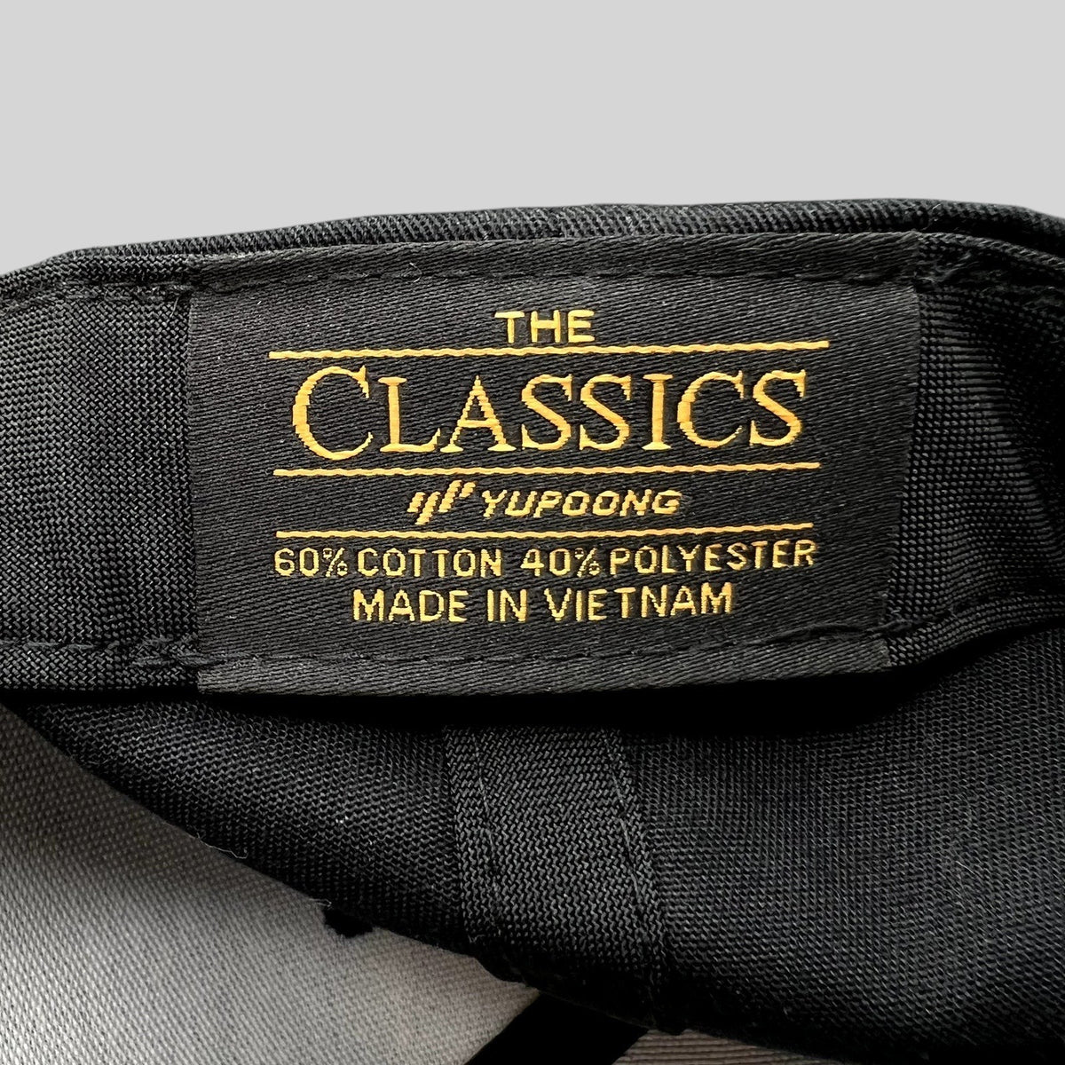 Raree Finds Yupoong Classics snapback hat interior label showing material composition and manufacturing origin