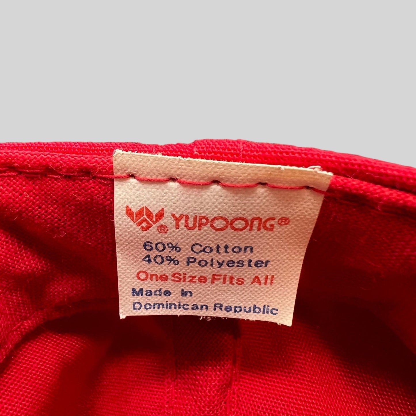 Raree Finds vintage Yupoong hat interior tag showing 60 percent cotton and 40 percent polyester fabric composition