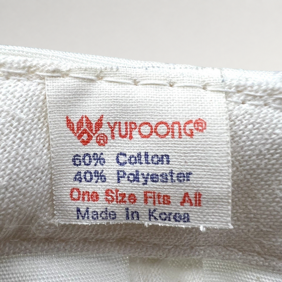 Raree Finds vintage Yupoong hat interior tag showing 60 percent cotton and 40 percent polyester blend made in Korea
