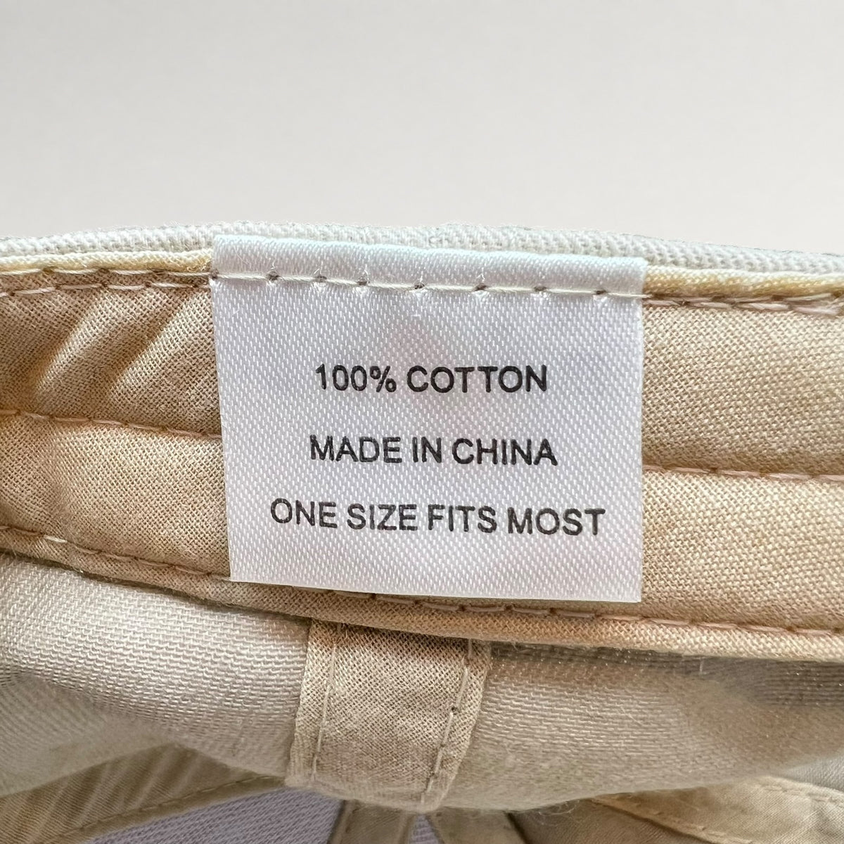 Label showing 100% cotton, made in China, one size fits most