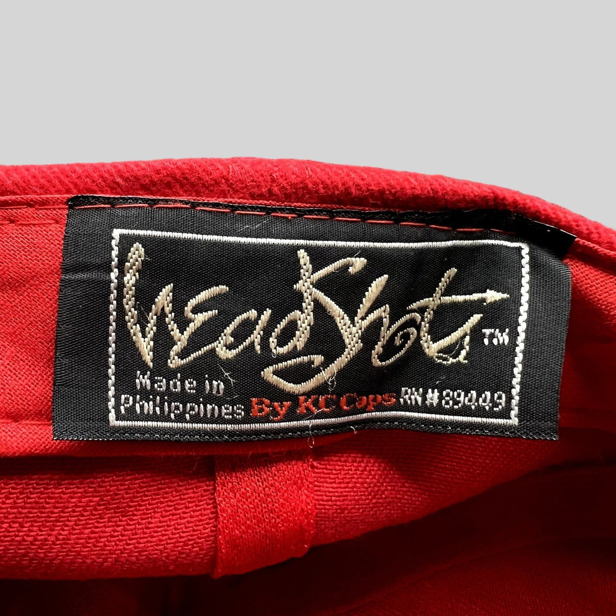 Raree Finds vintage Headshots by KC Caps label inside a bright red promotional hat made in the Philippines