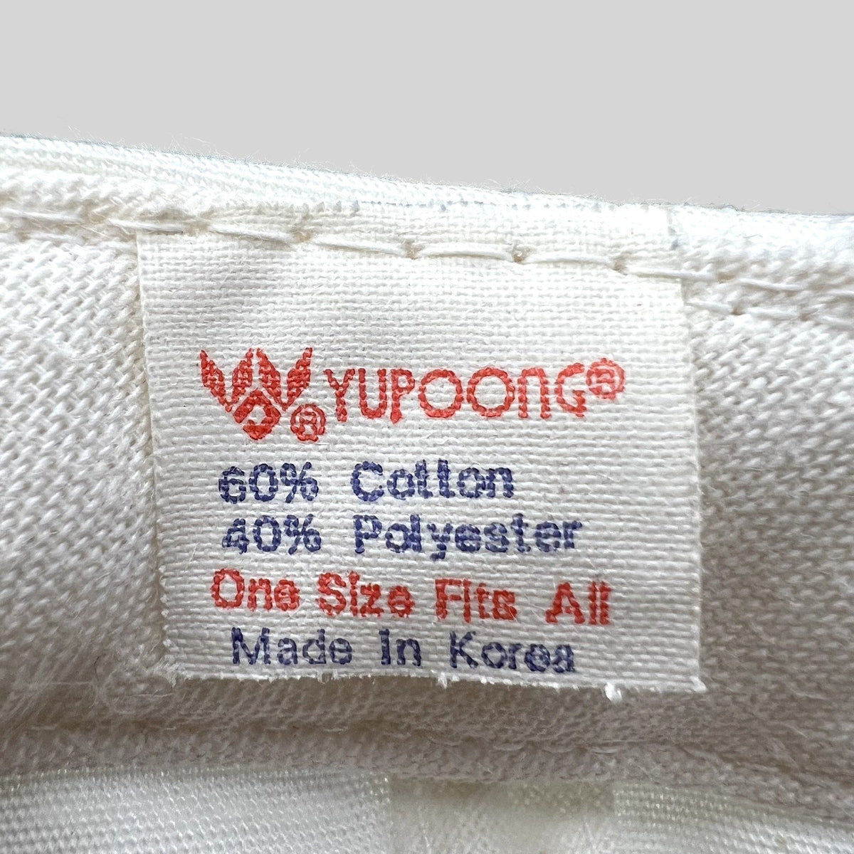 Raree Finds vintage Yupoong hat interior tag showing 60 percent cotton and 40 percent polyester blend made in Korea