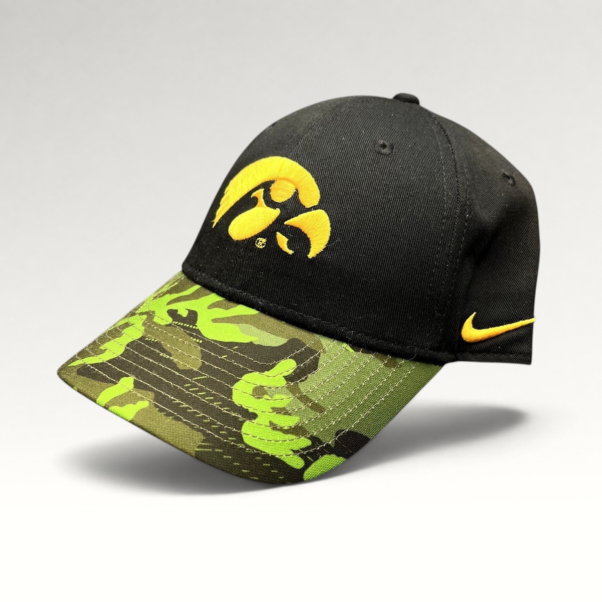 Raree Finds Nike Iowa Hawkeyes Legacy91 strapback hat with a black crown, gold logo, and green camouflage visor.