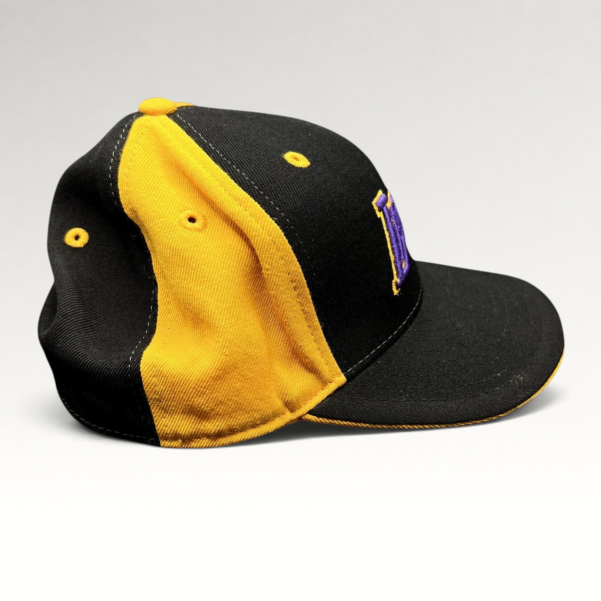Raree Finds vintage Reebok Los Angeles Lakers fitted hat in black and gold with purple embroidery on a grey background