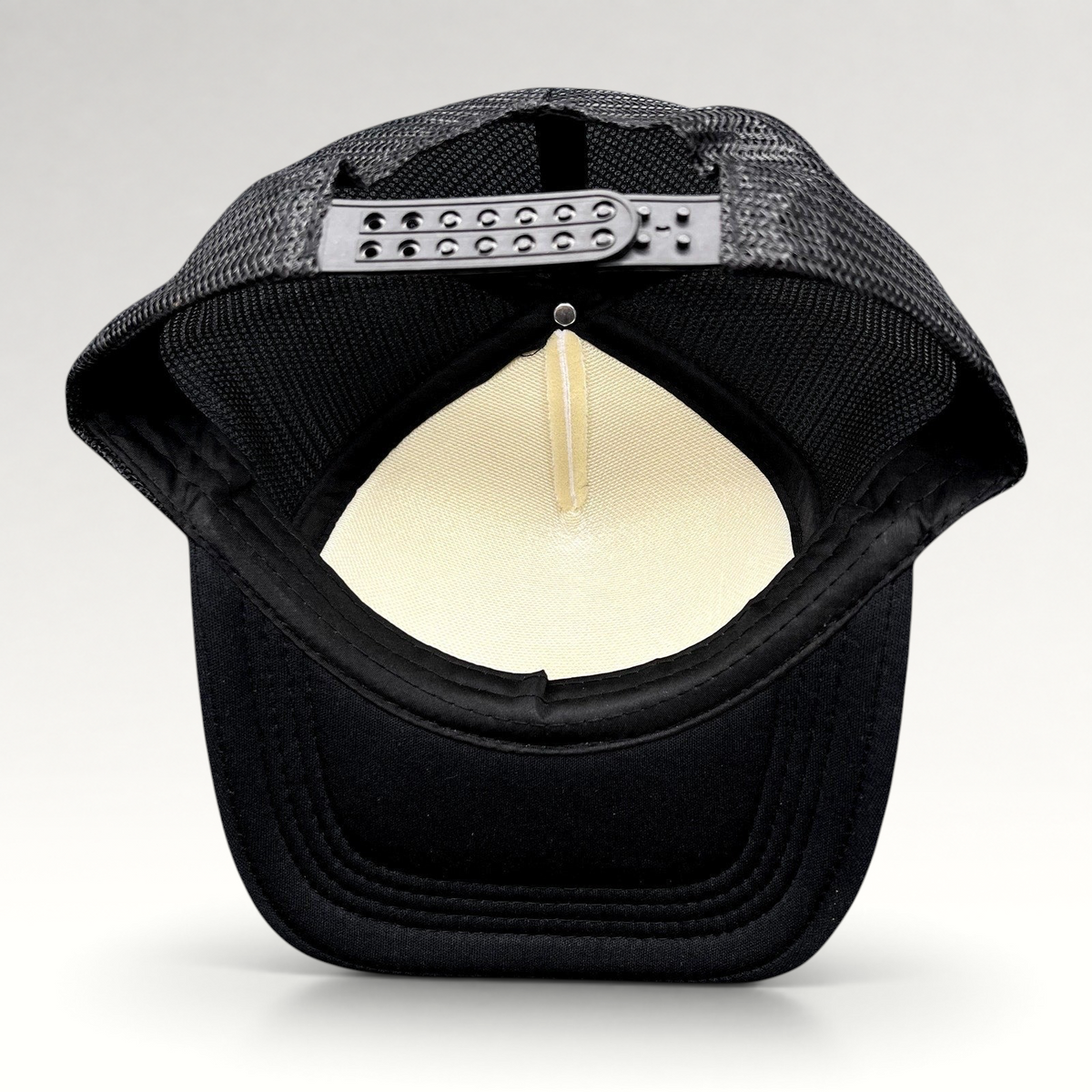 Raree Finds novelty trucker hat back view showing black mesh, adjustable snapback closure, and white foam interior.