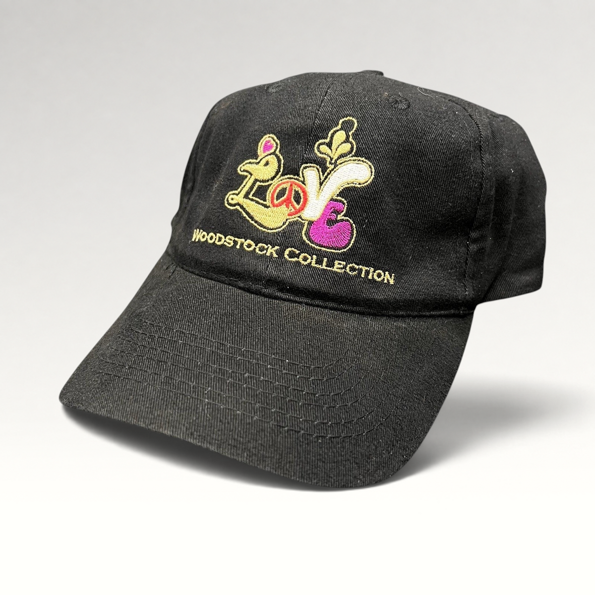 Raree Finds black cotton strapback hat with colorful embroidered Woodstock Collection Love logo and peace sign.