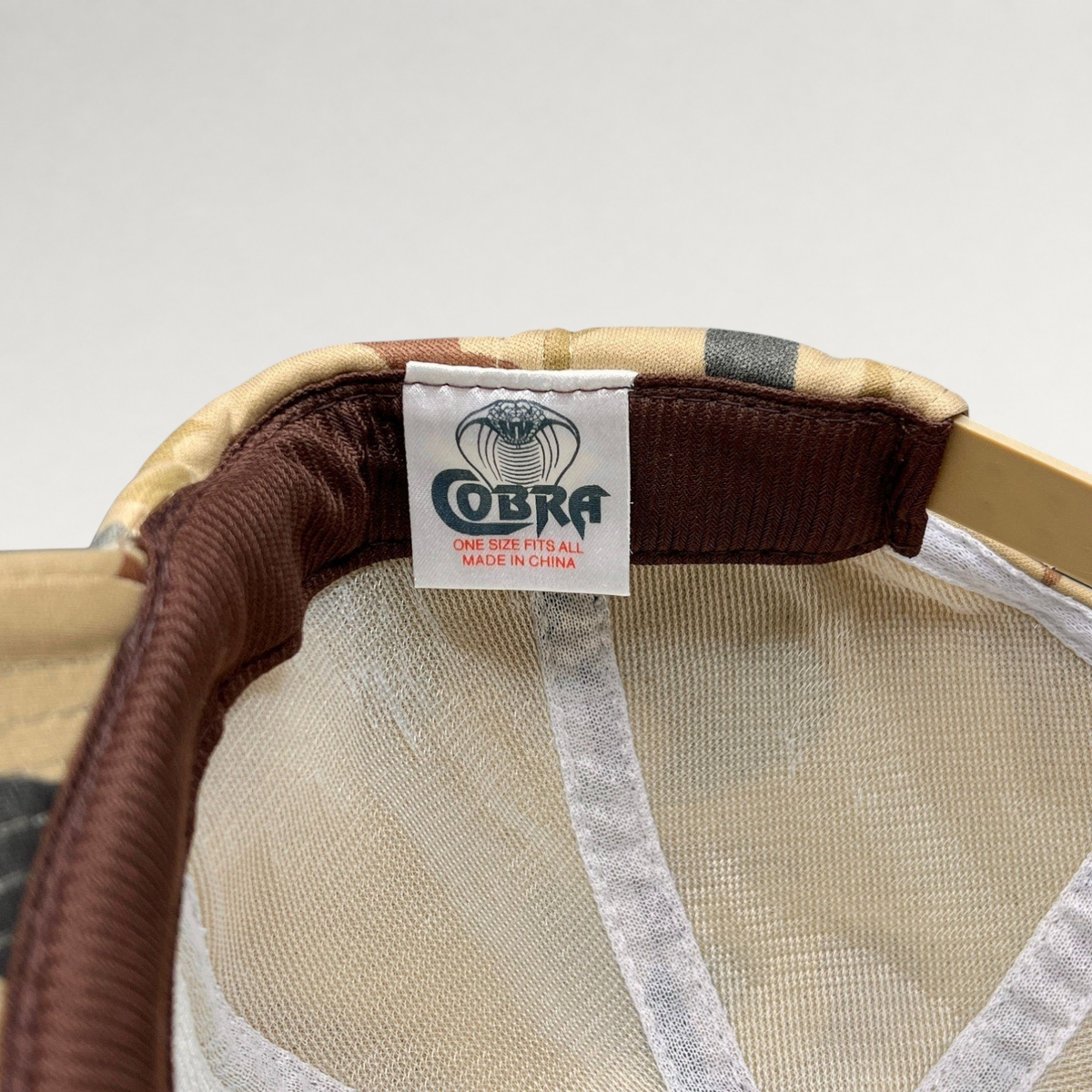 Raree Finds vintage Bonfire Brewing Co snapback interior showing the COBRA manufacturer tag and tan camo fabric