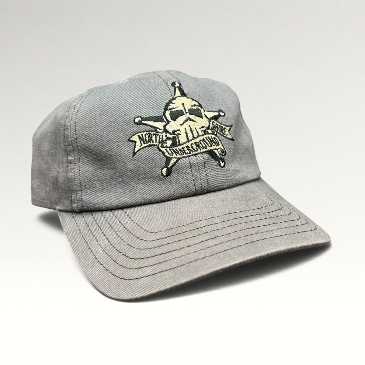 Three-quarter front view of gray North Shore Underground snapback hat