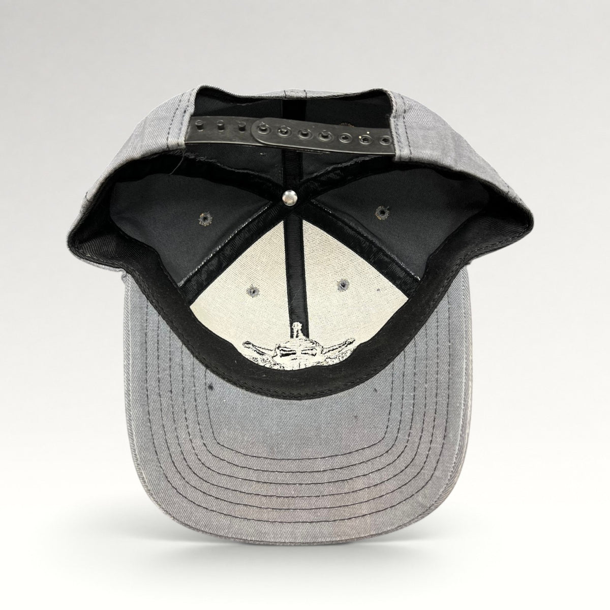 Interior and adjustable snapback closure of North Shore Underground hat