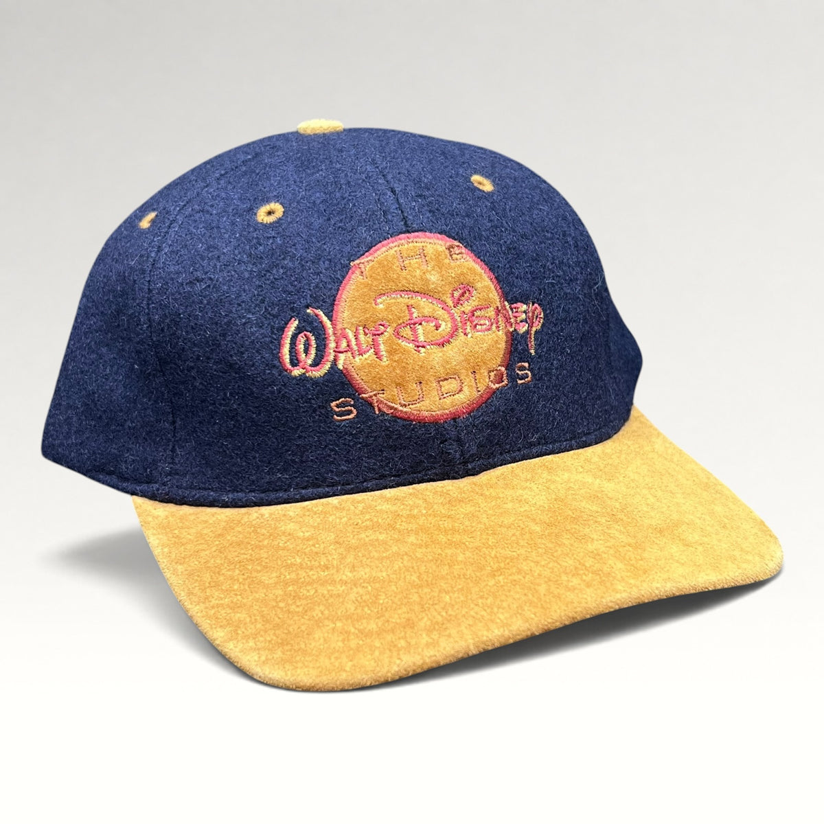 Vintage 1990s Walt Disney Studios navy and tan strapback hat, front right angle