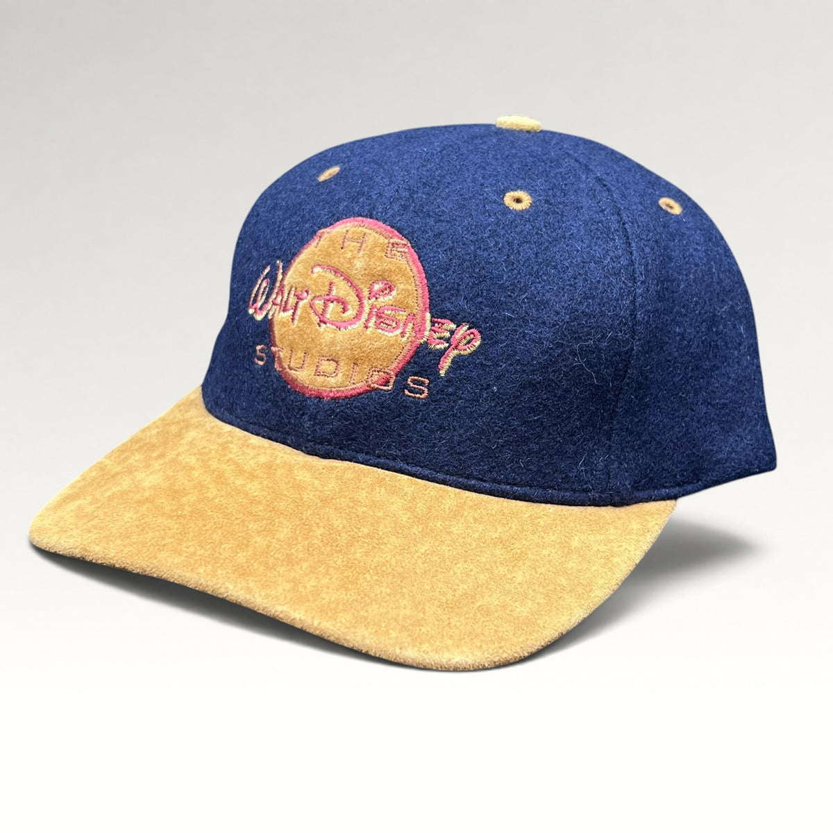 Vintage 1990s Walt Disney Studios navy and tan strapback hat, front left angle