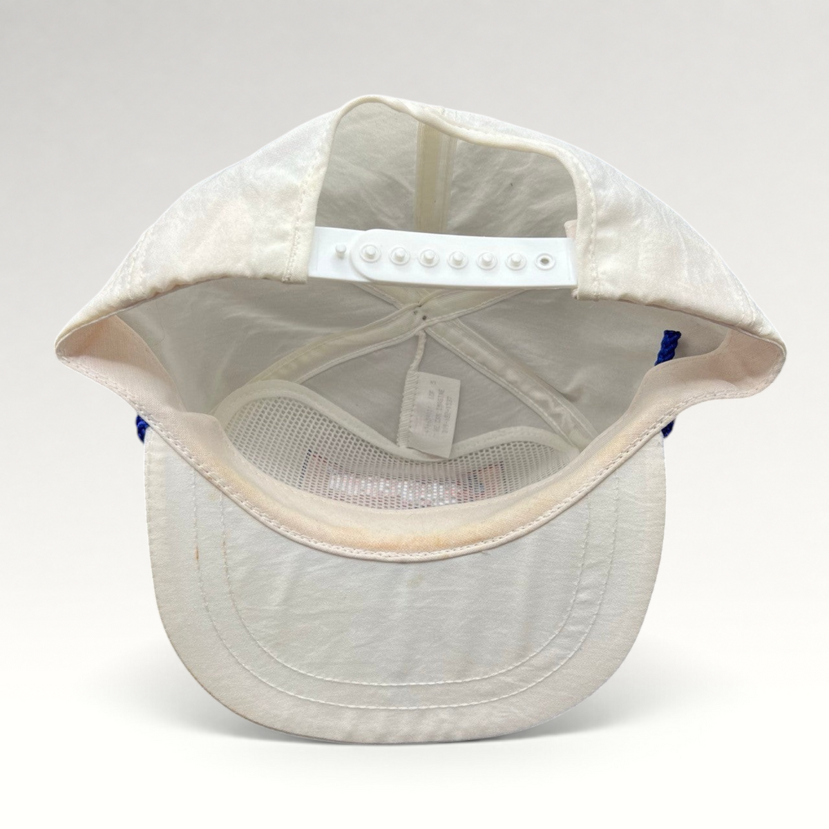 Vintage Hat Source vintage white Pepsi Wild Cherry snapback hat showing the adjustable plastic strap and interior mesh lining