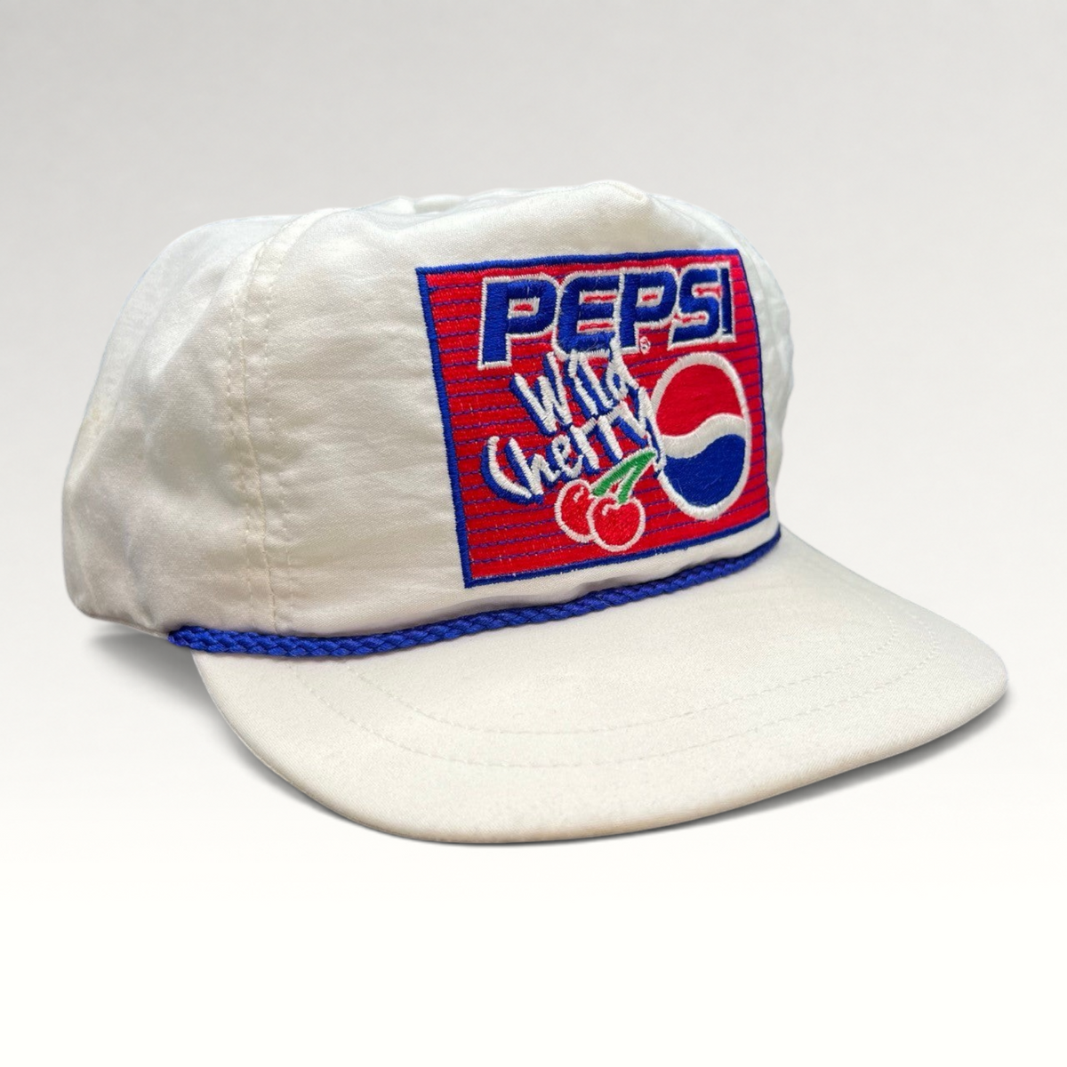Raree Finds vintage white Pepsi Wild Cherry snapback hat with embroidered logo patch and blue rope trim detail