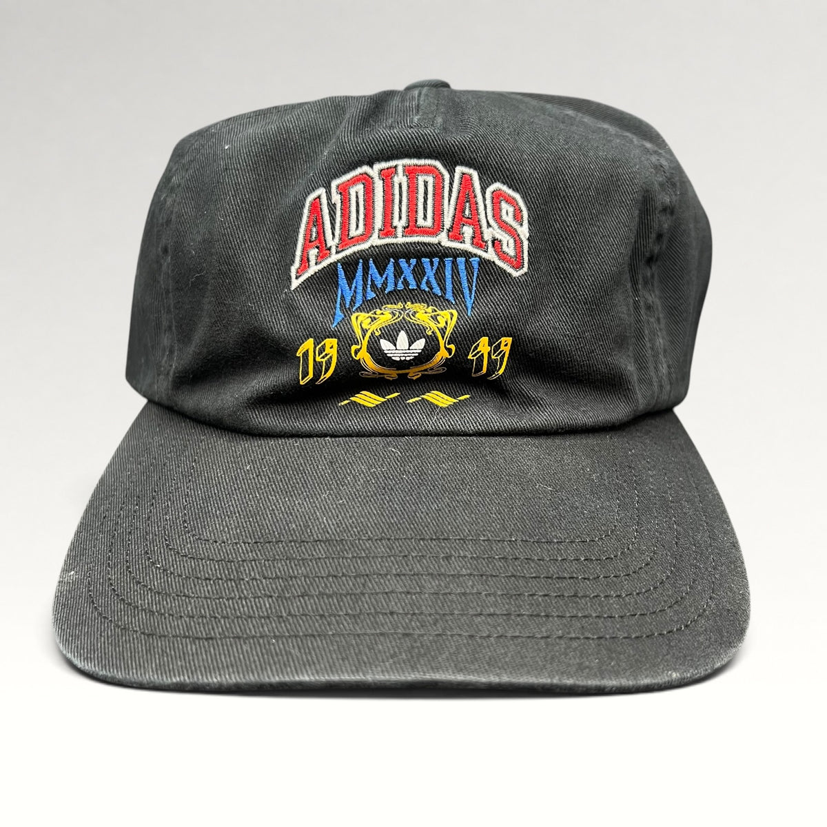 Front view of black Adidas Heritage collegiate spellout strapback