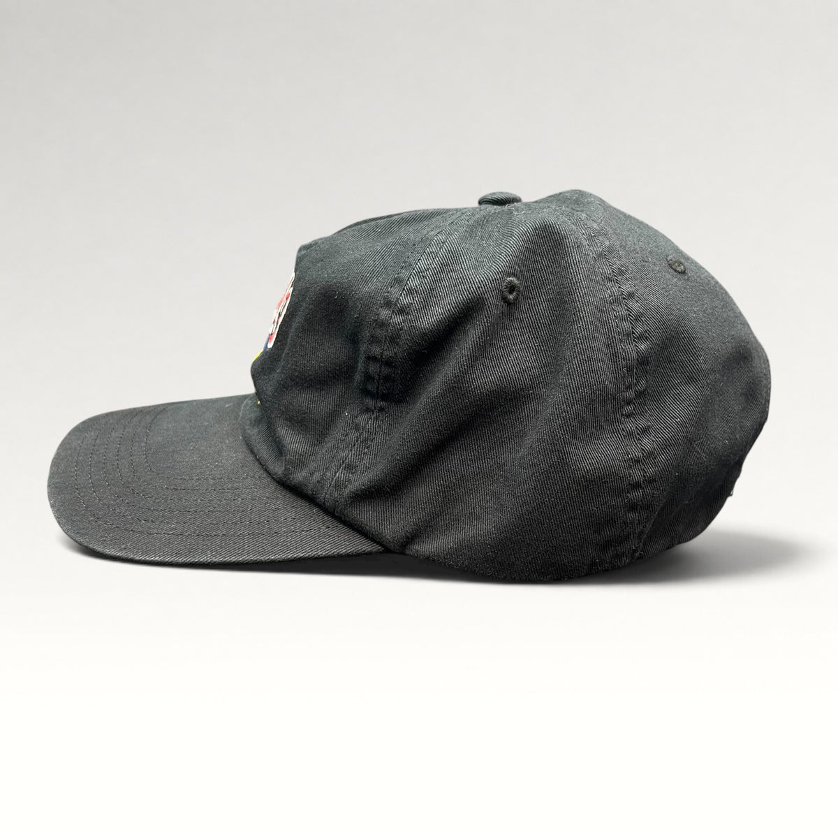 Side view of black Adidas cap