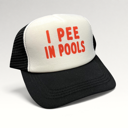 Raree Finds novelty trucker hat with white foam front, red I PEE IN POOLS text, black mesh back, and snapback closure.