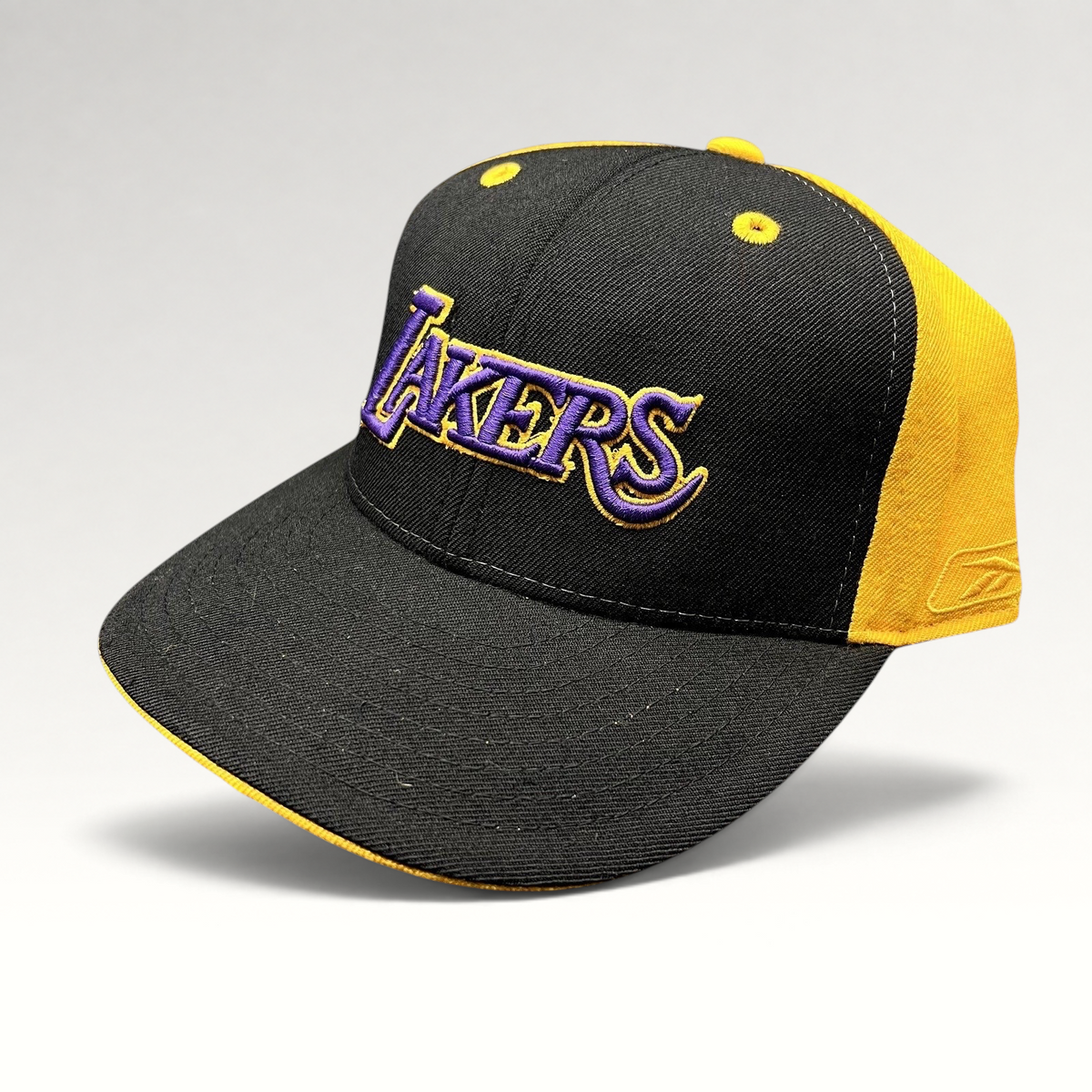 Raree Finds vintage Reebok Los Angeles Lakers fitted hat in black with purple and gold embroidered script logo