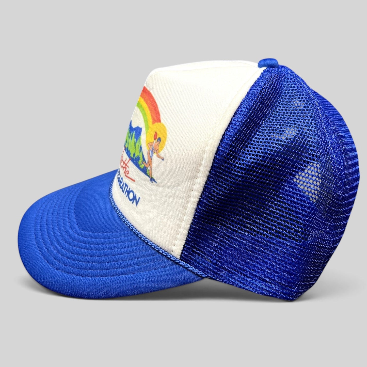 Raree Finds vintage 1983 Honolulu Marathon trucker hat with white foam front, blue mesh back, and rainbow graphic