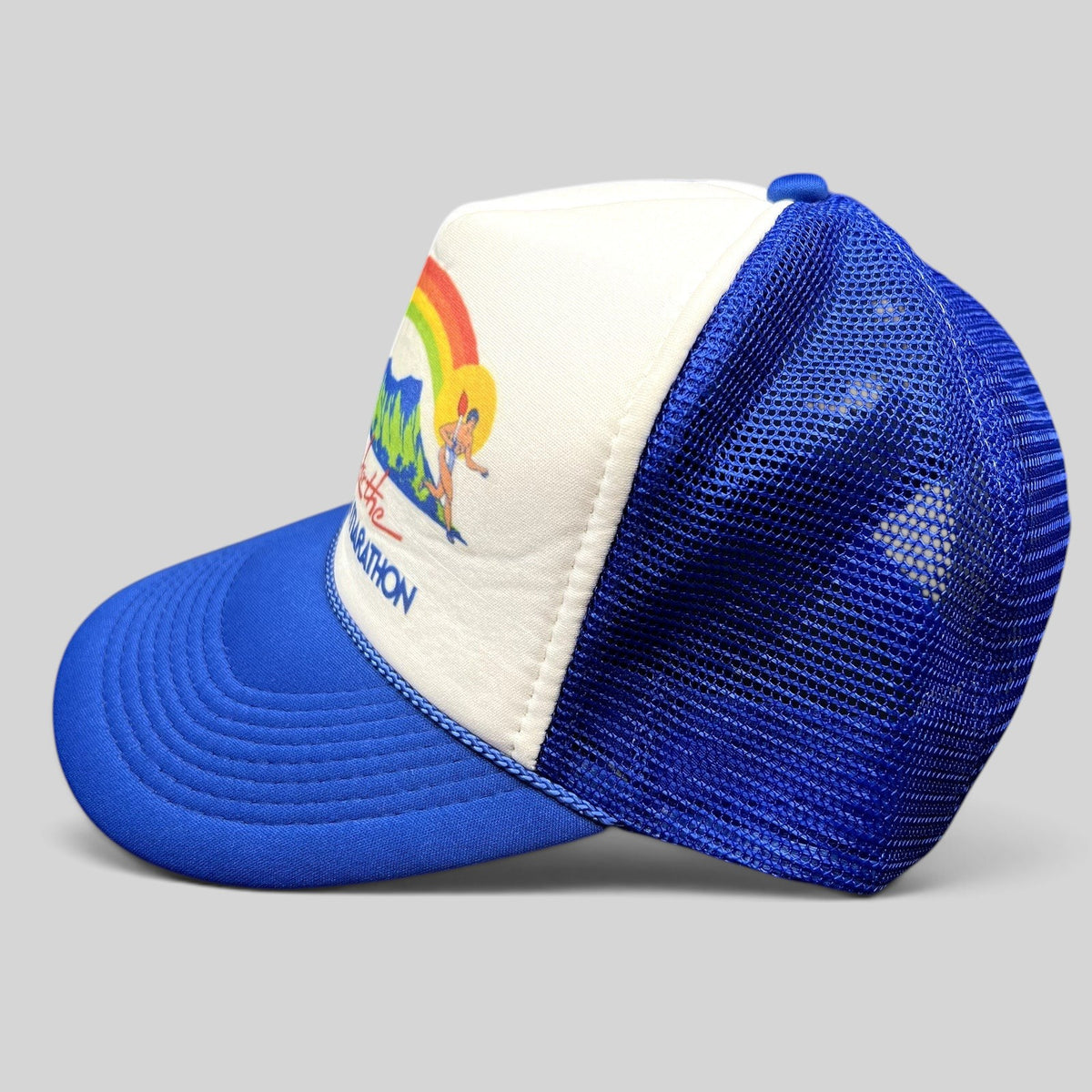 Raree Finds vintage 1983 Honolulu Marathon trucker hat with white foam front, blue mesh back, and rainbow graphic