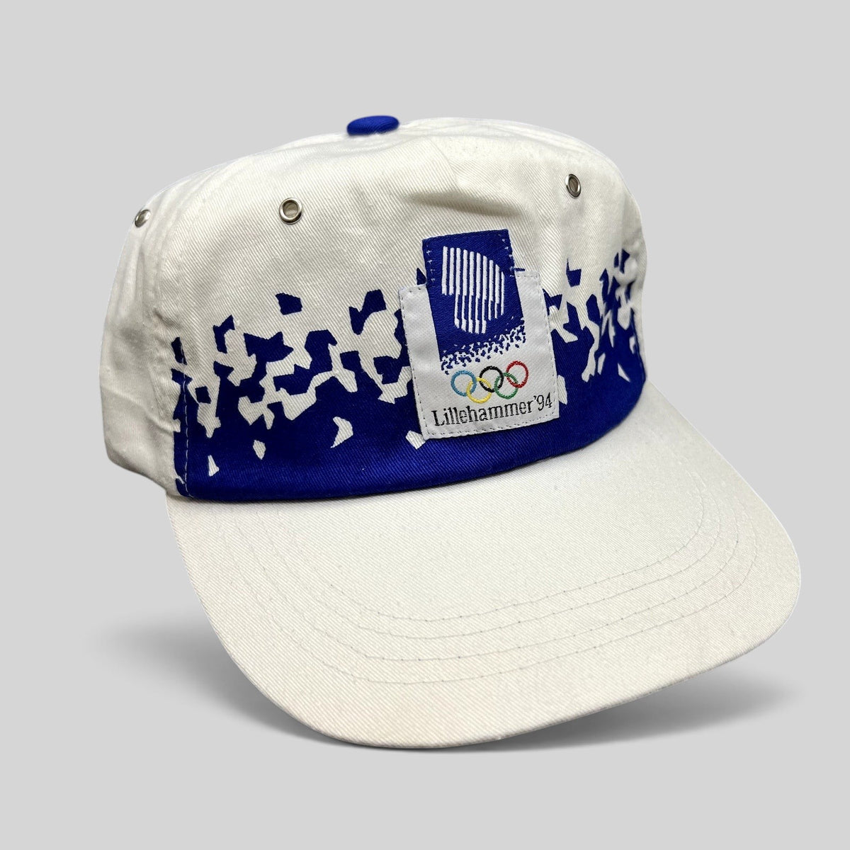 Raree Finds vintage 1994 Lillehammer Winter Olympics flex-back hat with white crown, blue brim, and Olympic logo patch.