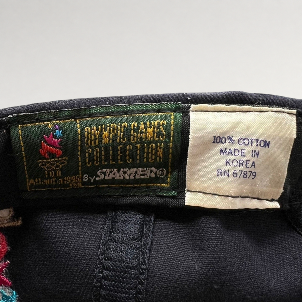 Raree Finds vintage 1996 Atlanta Olympics Starter hat interior label showing 100% cotton and made in Korea details