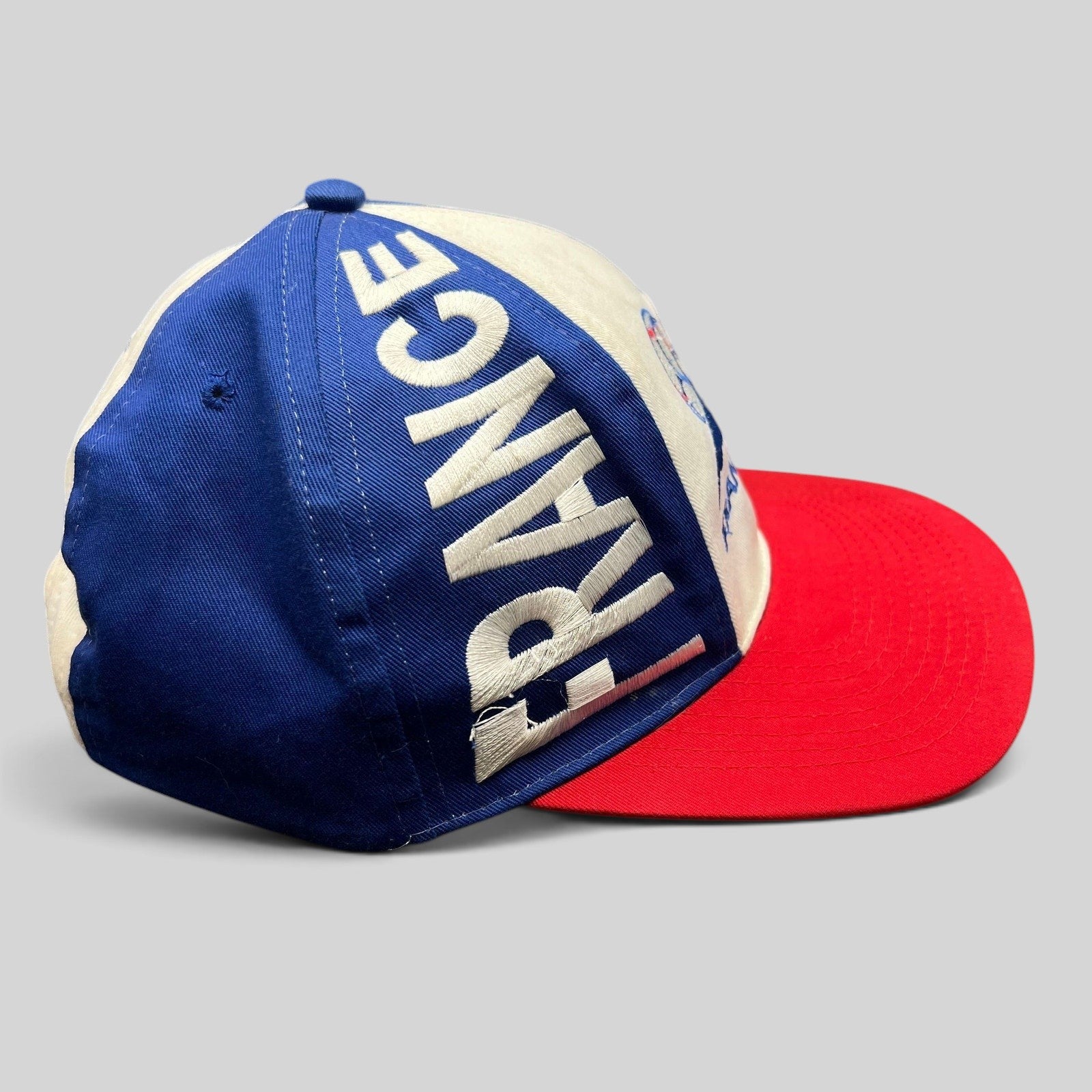 Raree Finds vintage 1998 France World Cup snapback hat in blue, white, and red with oversized side panel embroidery.