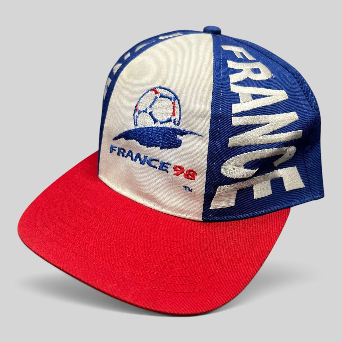 Raree Finds vintage 1998 France World Cup snapback hat in blue, white, and red with embroidered soccer logo.