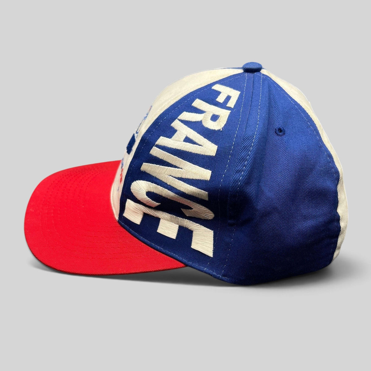 Raree Finds vintage 1998 France World Cup snapback hat in blue, white, and red with oversized side panel embroidery.
