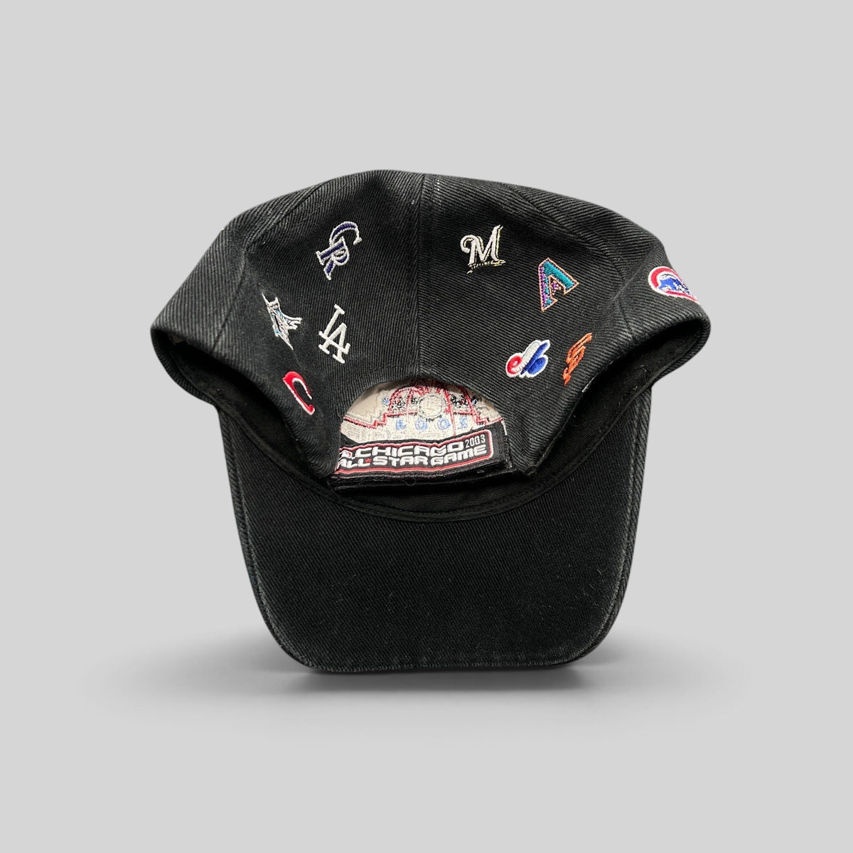 Raree Finds black cotton twill 2003 MLB All-Star Game hat featuring embroidered multi-team logos and adjustable strap.