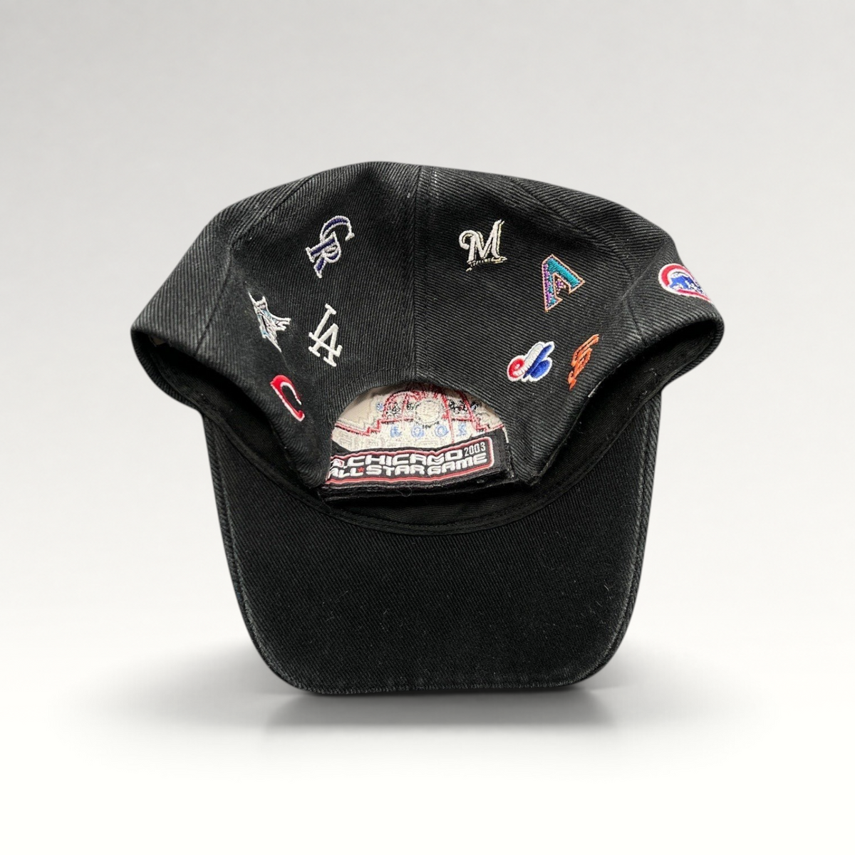 Raree Finds black cotton twill 2003 MLB All-Star Game hat featuring embroidered multi-team logos and adjustable strap.
