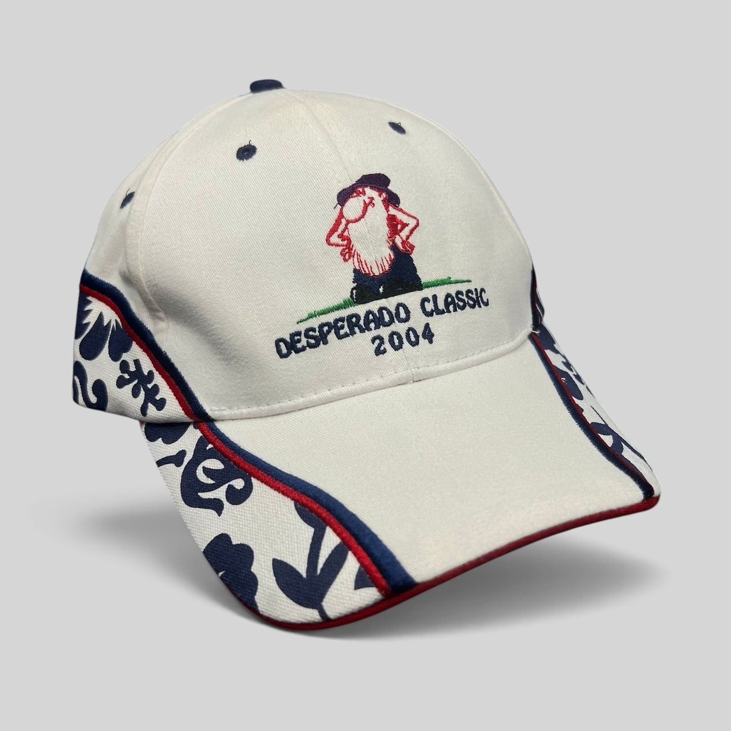 Raree Finds 2004 Desperado Golf Classic white cotton strapback hat with western embroidered logo and patterned sides