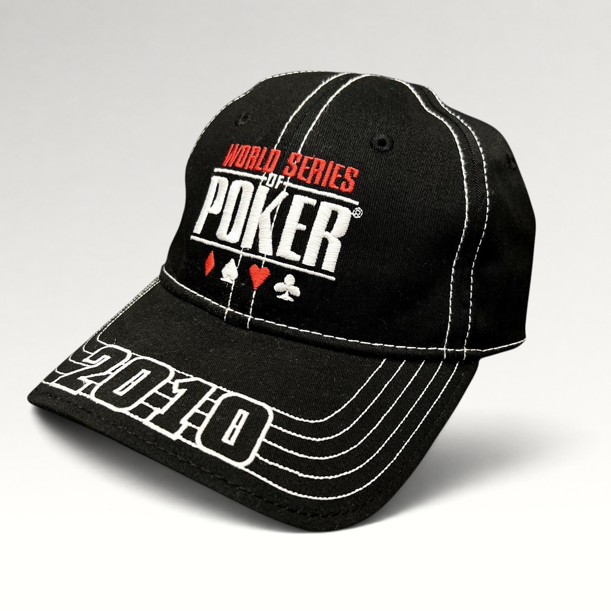 Raree Finds black 2010 World Series of Poker flexfit hat with embroidered logo, card suits, and brim stitching.