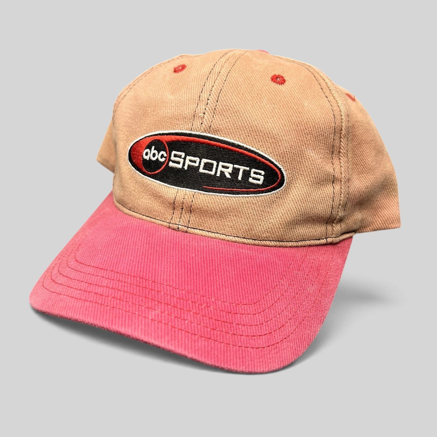 Raree Finds vintage ABC Sports two-tone strapback hat with a tan crown, pink brim, and embroidered logo.