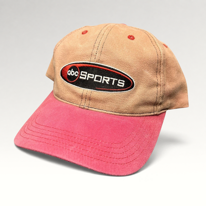 Raree Finds vintage ABC Sports two-tone strapback hat with a tan crown, pink brim, and embroidered logo.