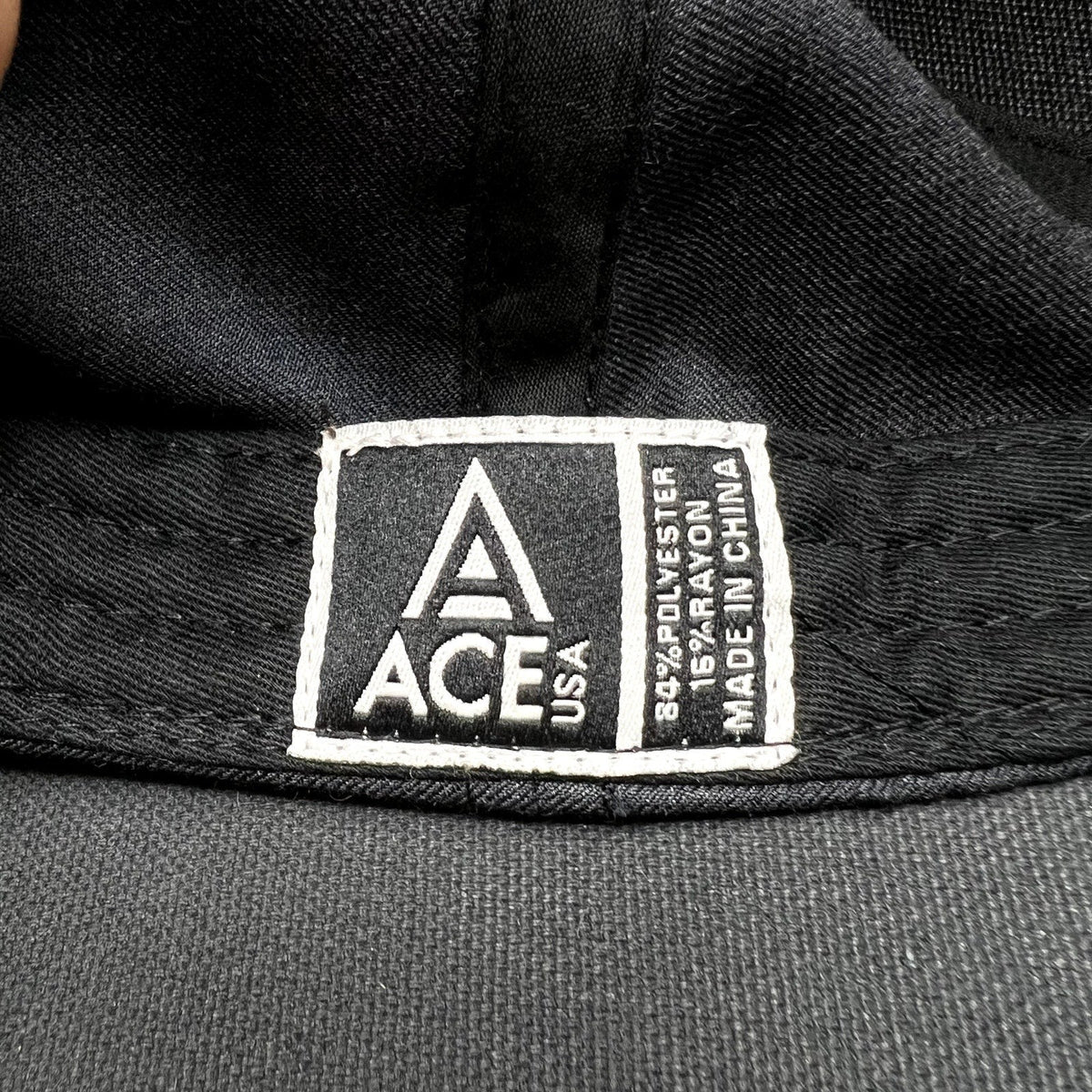 Raree Finds ACE USA black cotton hat interior label showing material composition and origin