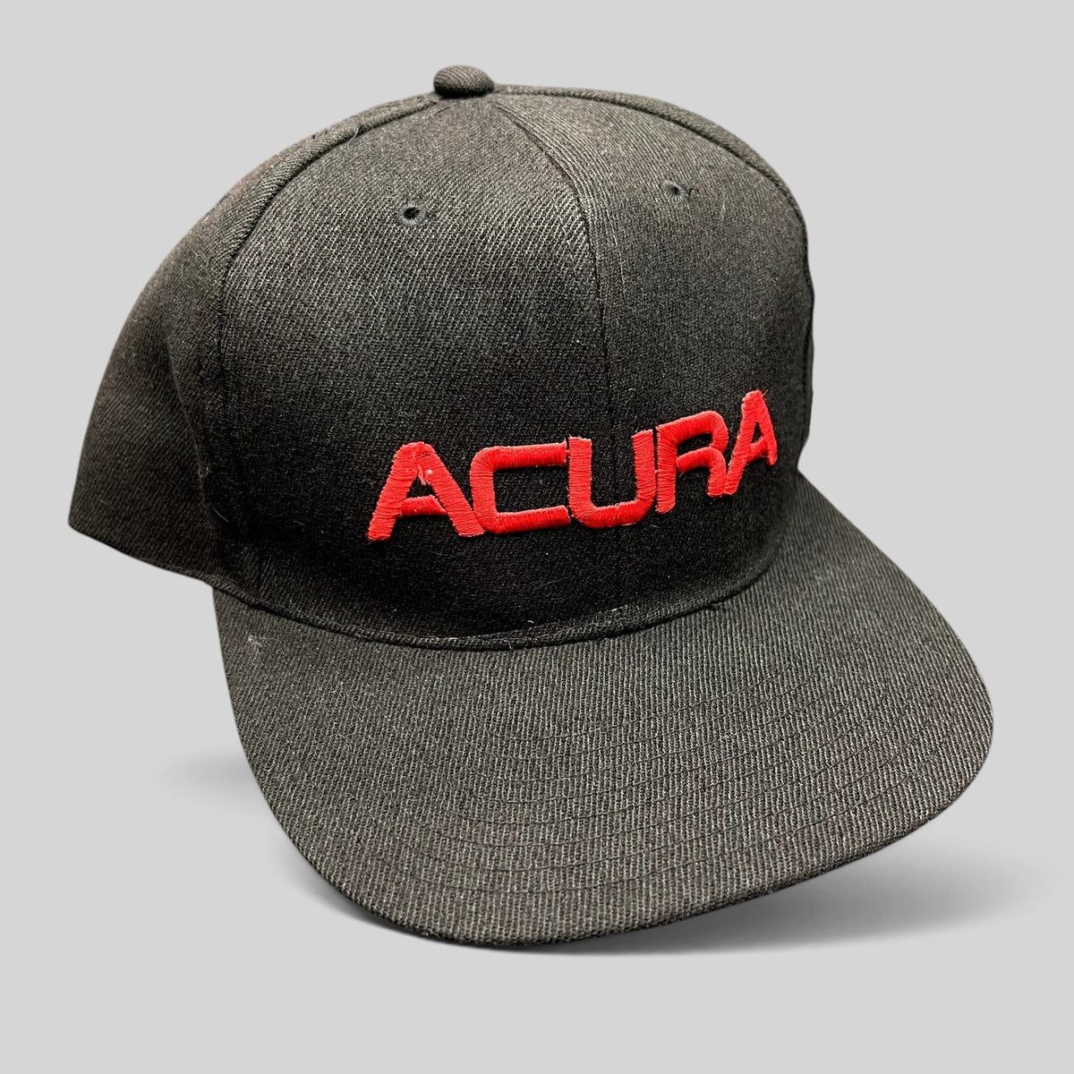 Raree Finds black Acura snapback hat with raised red embroidered logo on a structured six-panel flat brim cap.