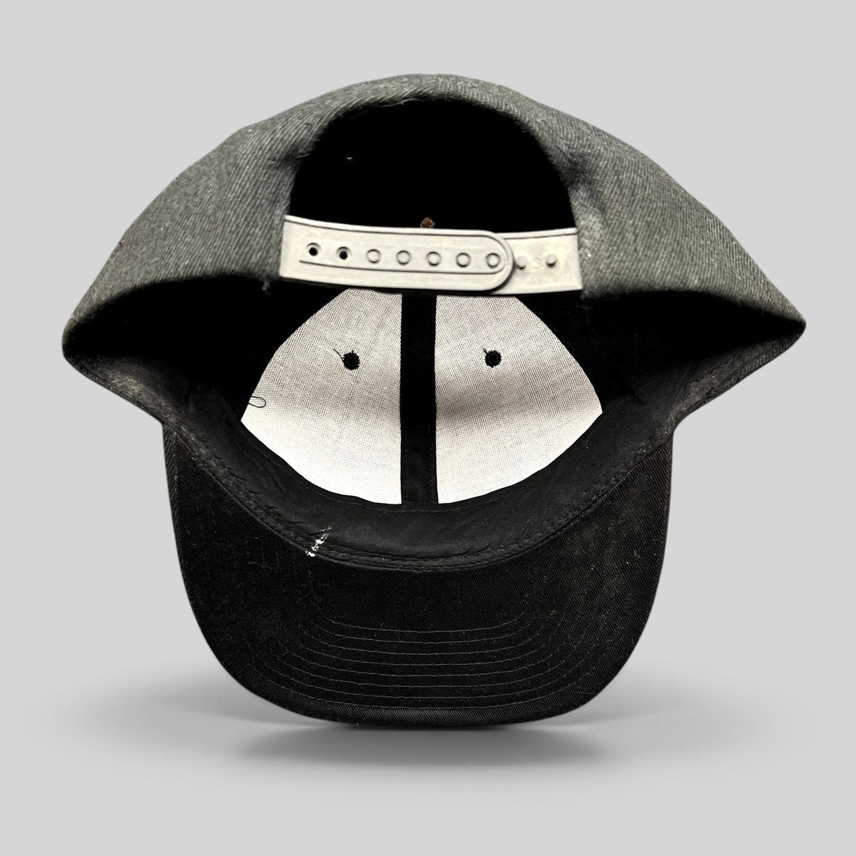 Raree Finds black Acura snapback hat showing the interior six-panel construction and adjustable plastic snap closure.