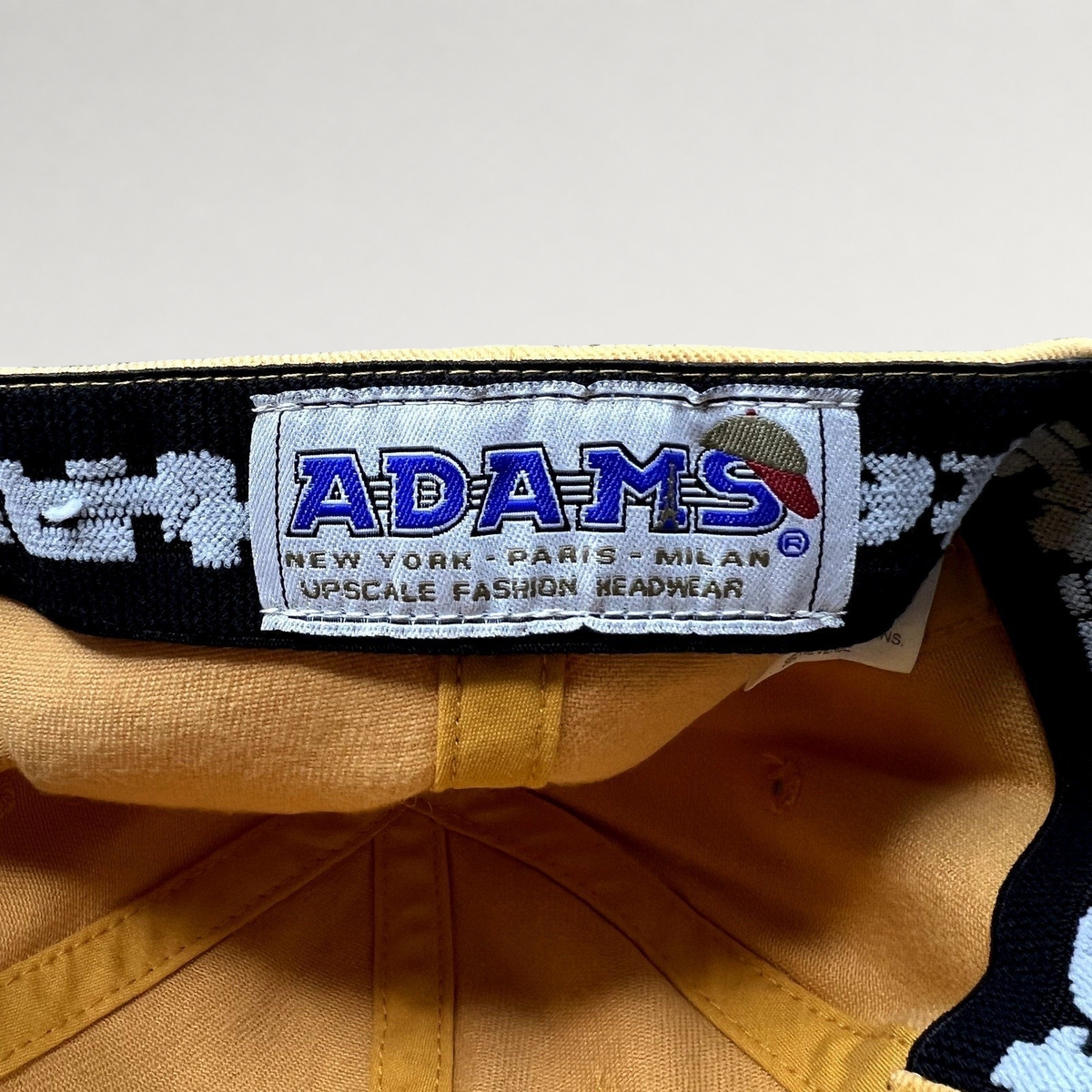 Raree Finds vintage ADAMS cotton hat interior label showing branding and construction details in tan and black