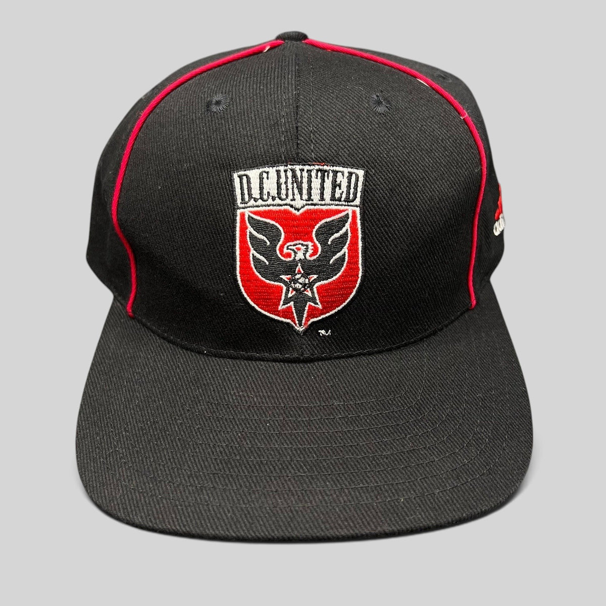 Raree Finds vintage Adidas DC United MLS snapback hat in black with red piping and embroidered eagle crest logo.