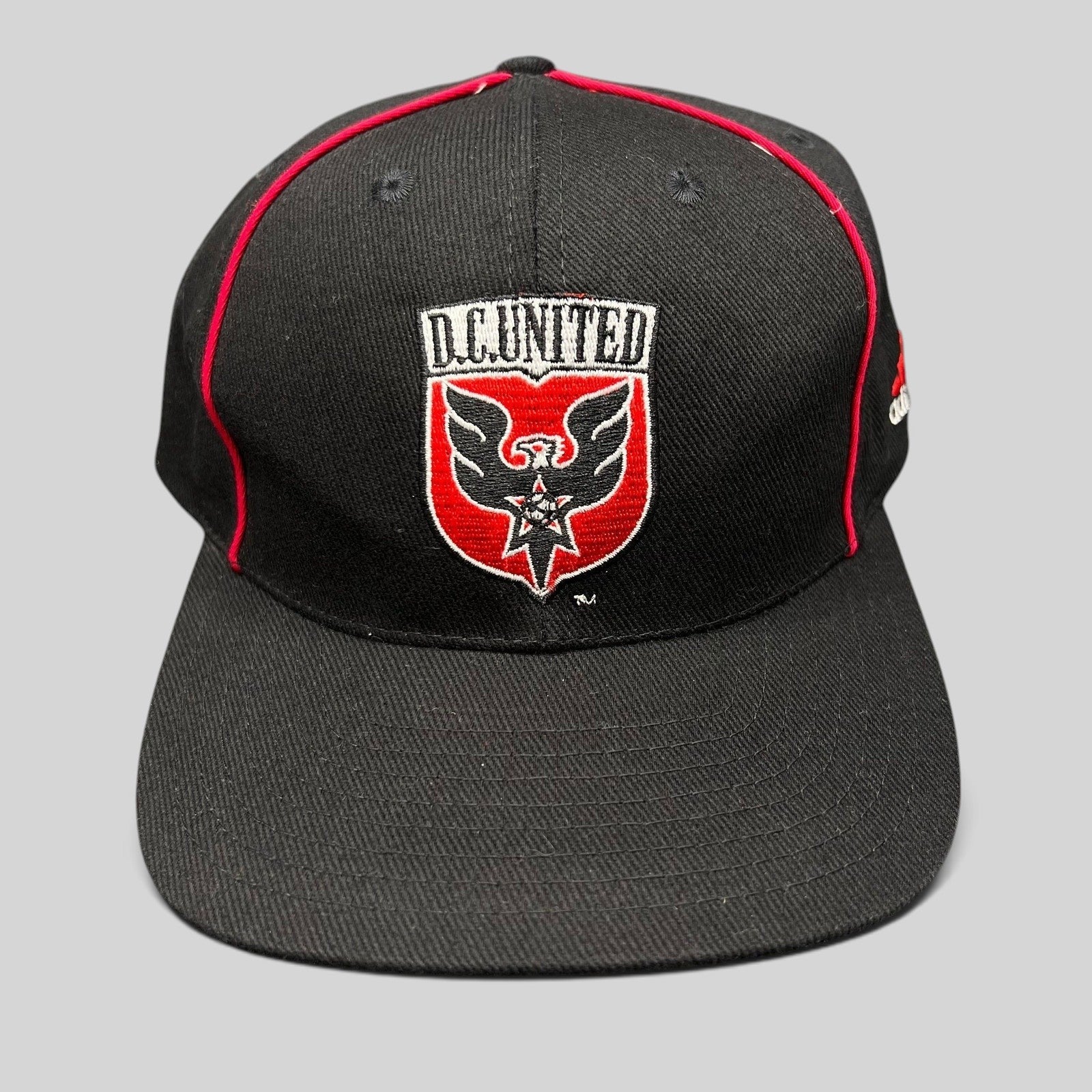 Raree Finds vintage Adidas DC United MLS snapback hat in black with red piping and embroidered eagle crest logo.