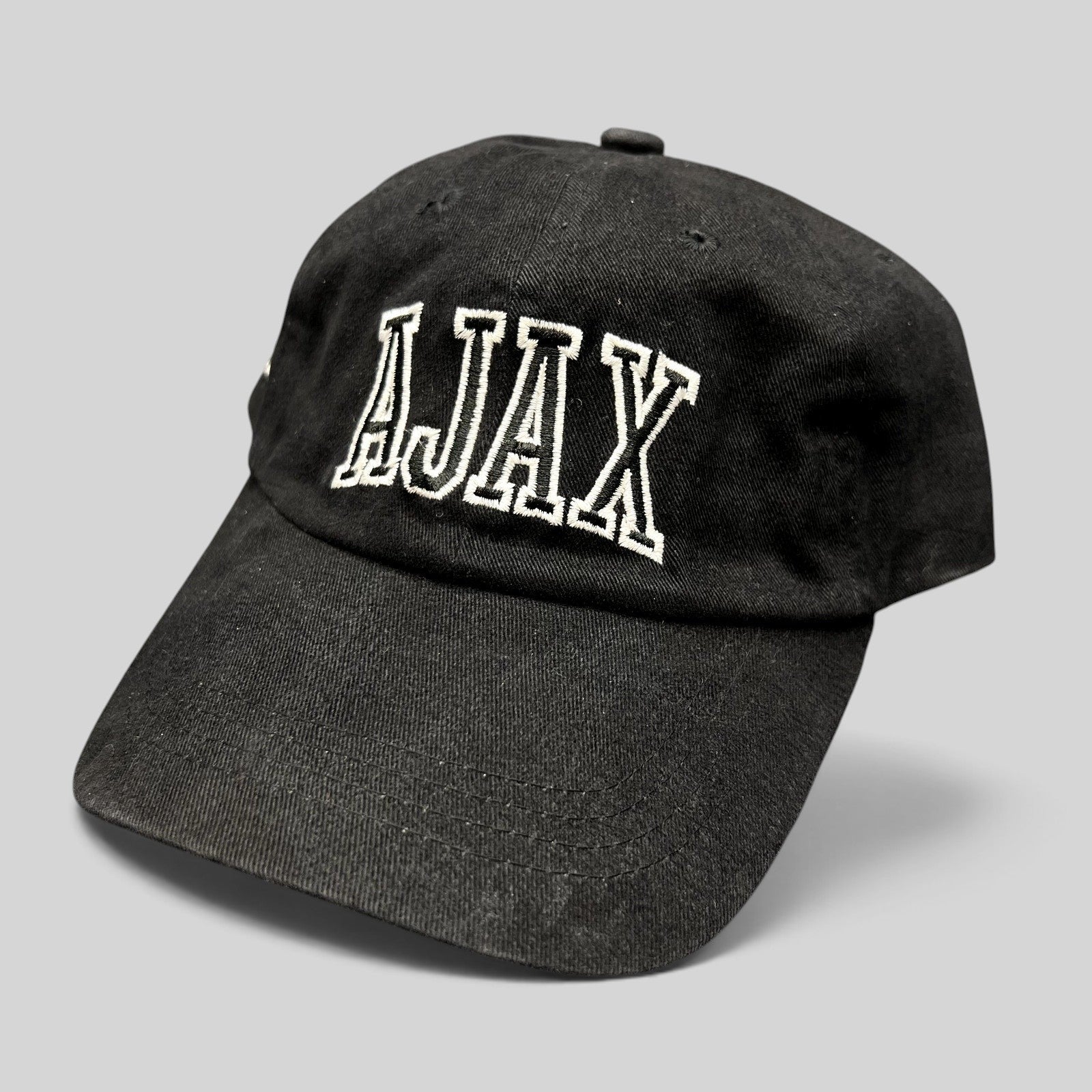 Raree Finds black cotton Aspen Snowmass AJAX strapback hat with white embroidered lettering on the front