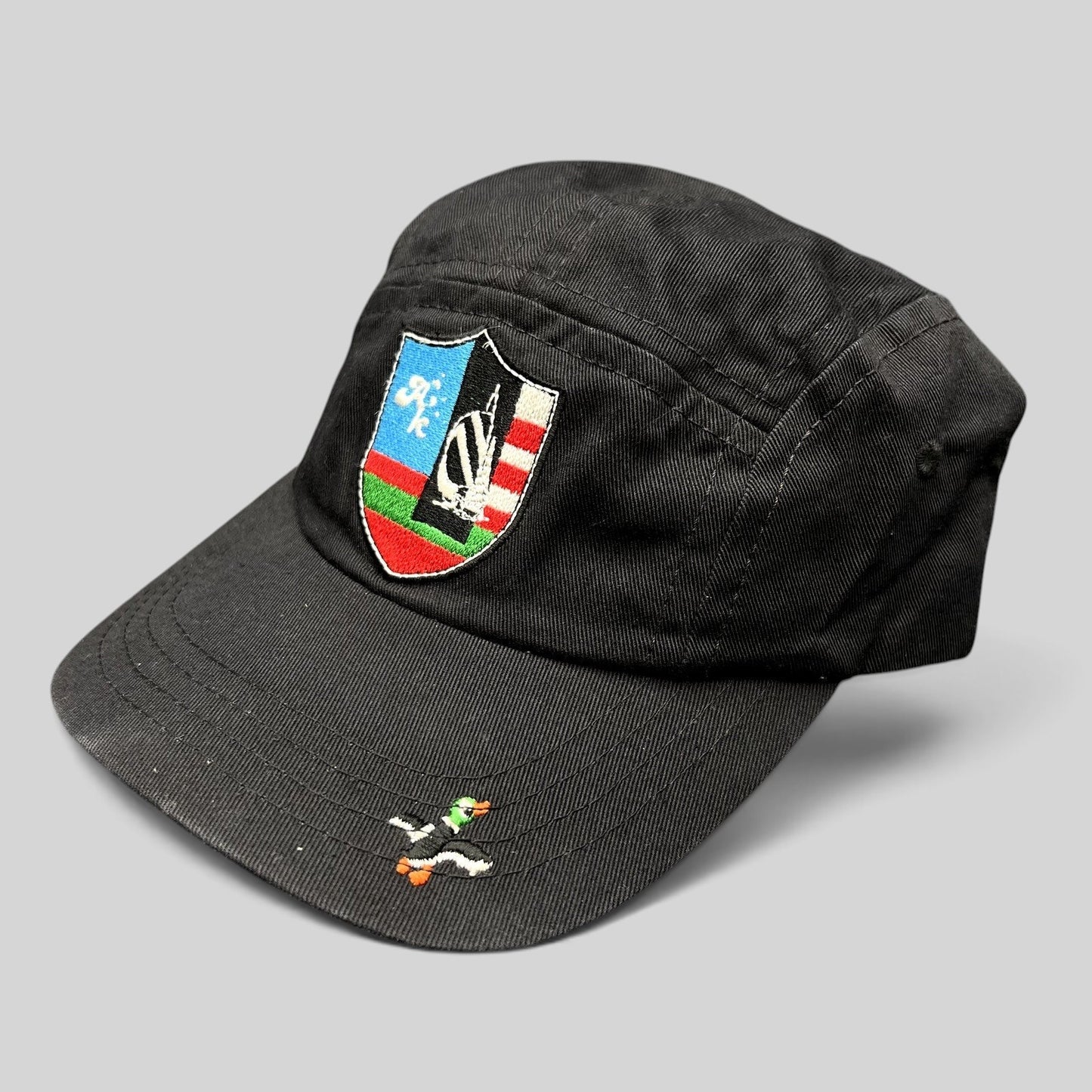 Raree Finds Akomplice Clothing black cotton strapback hat with a colorful crest patch and small duck brim embroidery