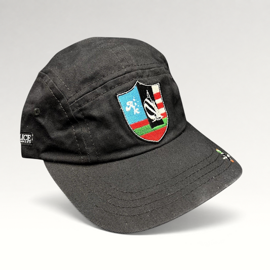 Raree Finds black Akomplice Clothing strapback hat with a colorful embroidered crest patch and mini brim graphic.