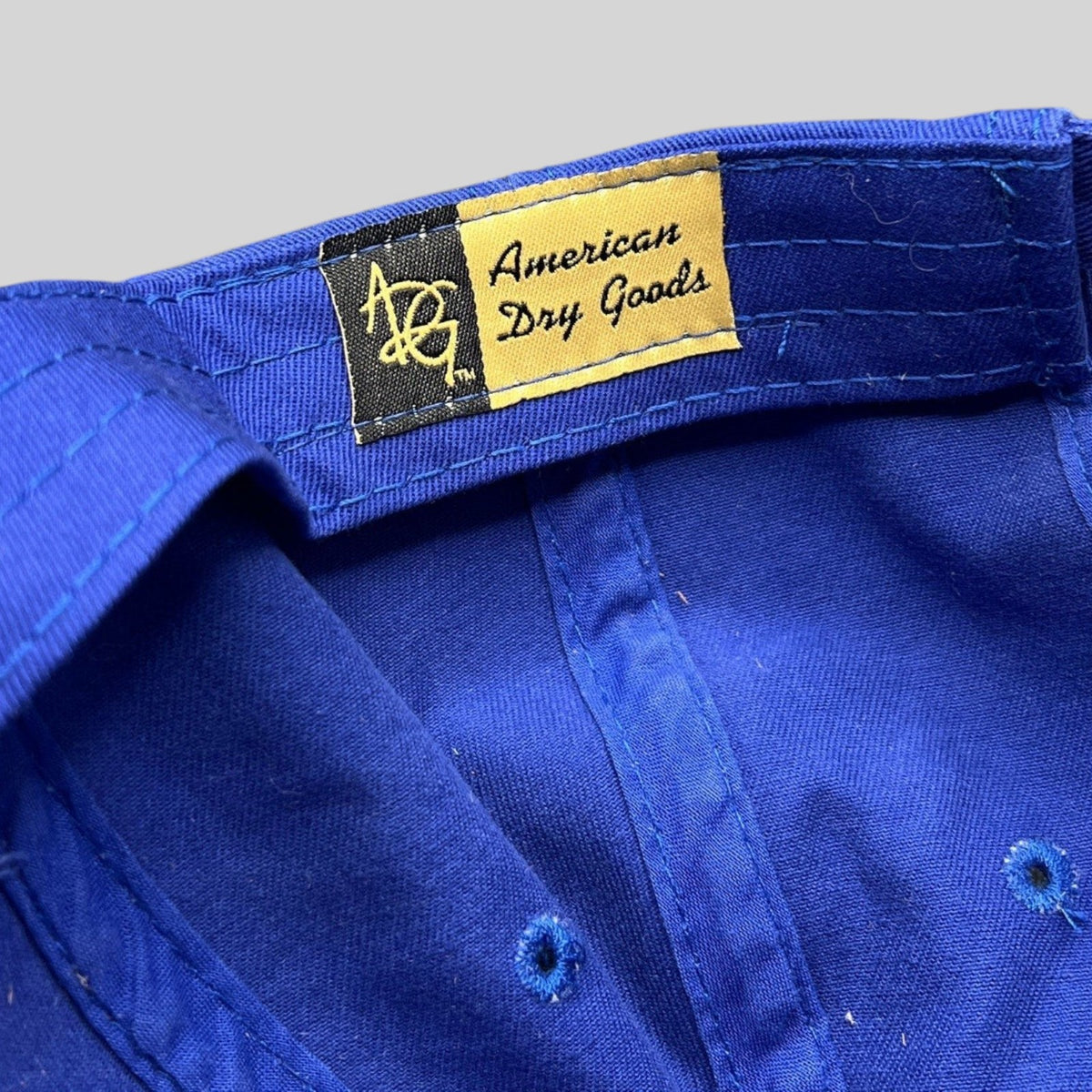 Raree Finds vintage American Dry Goods label inside a royal blue cotton golf hat