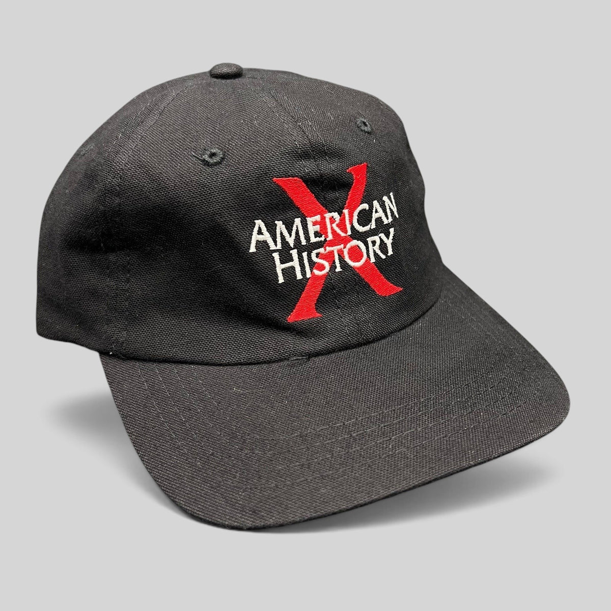 Raree Finds vintage 1998 American History X black cotton snapback hat with red X and white embroidered logo.