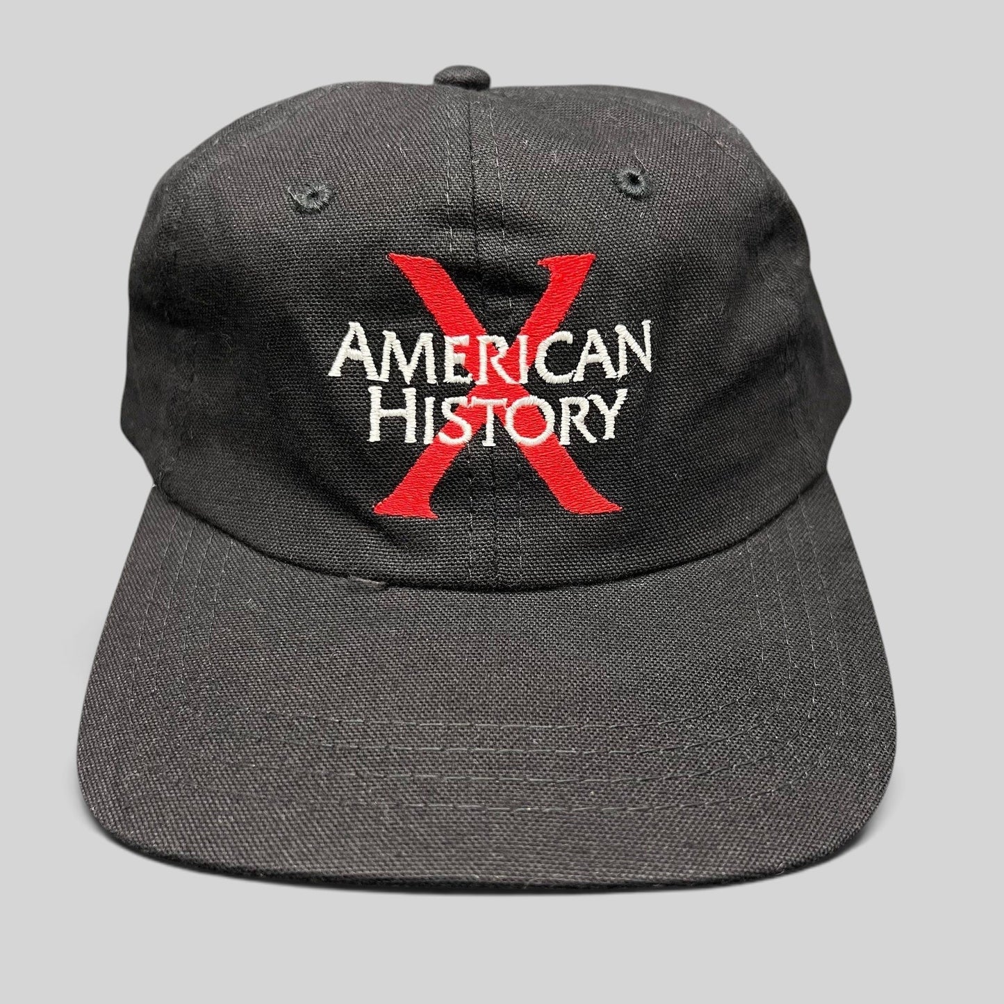 Raree Finds vintage 1998 American History X promotional black cotton snapback hat with red X and white embroidery.