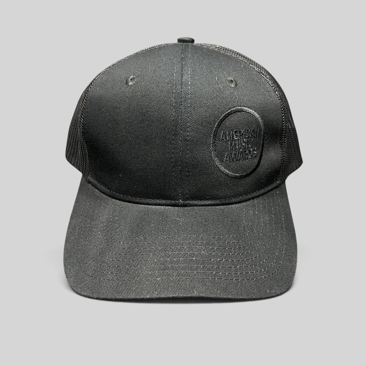 Raree Finds American Music Awards blackout trucker hat with tonal black embroidered logo and mesh back