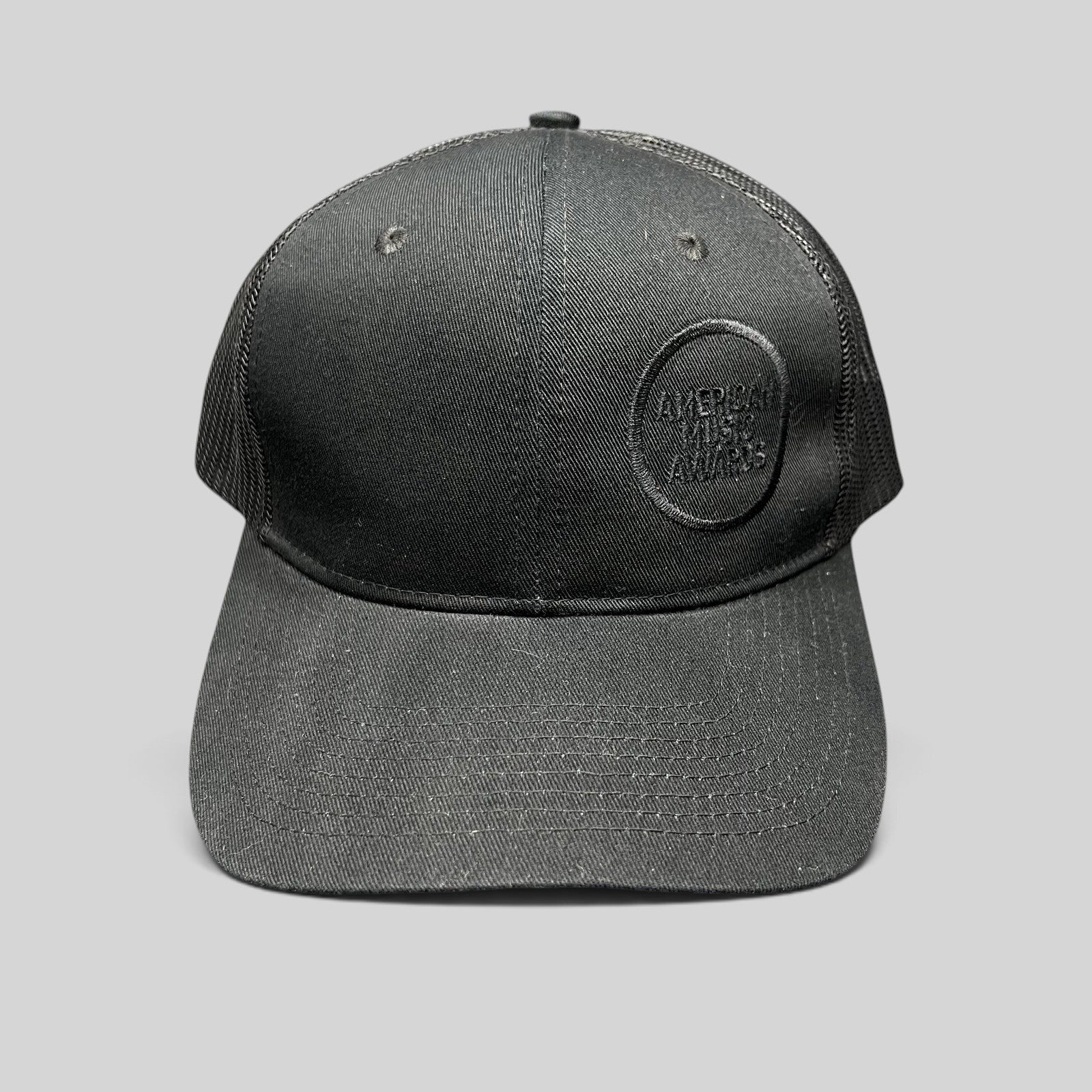 Raree Finds American Music Awards blackout trucker hat with tonal black embroidered logo and mesh back