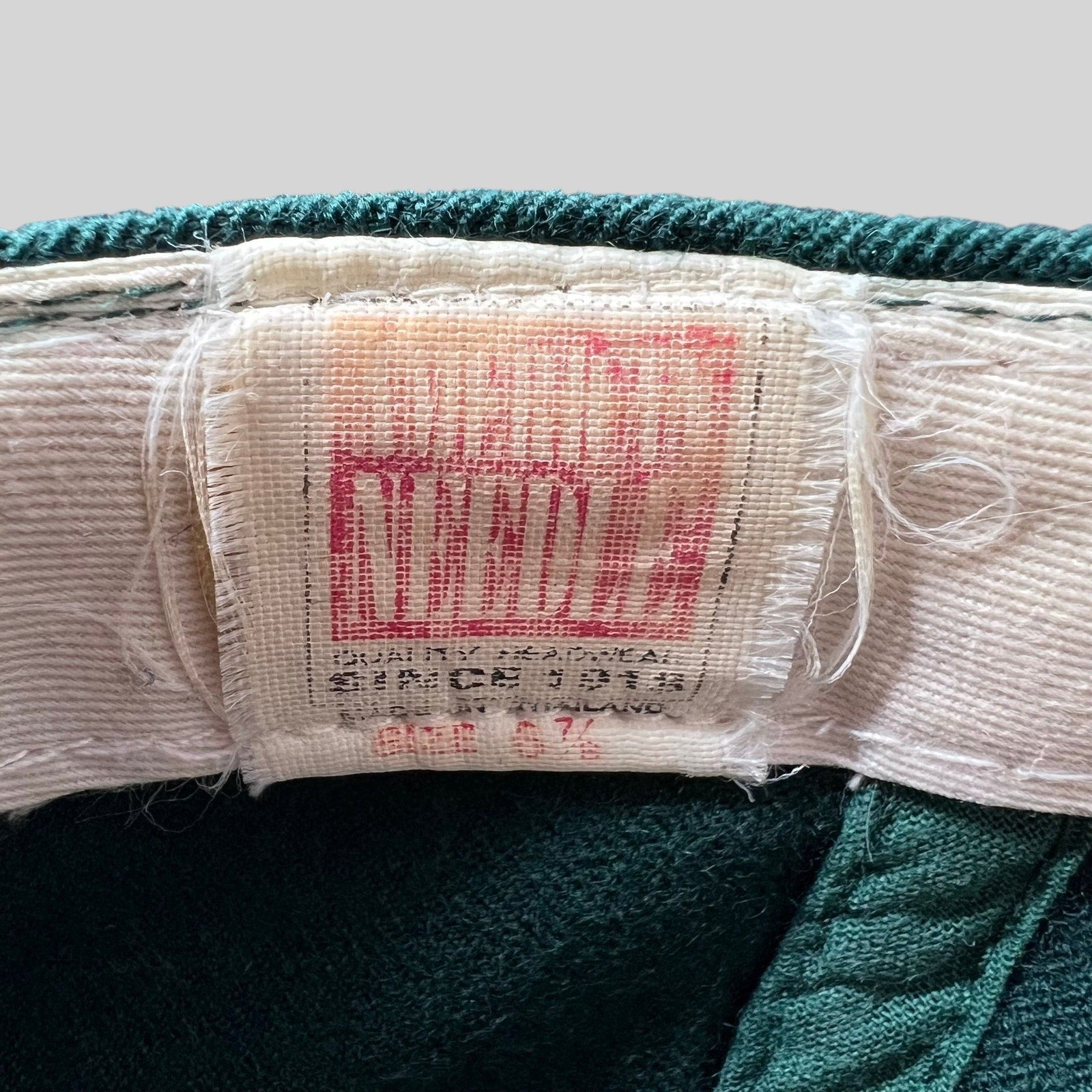 Raree Finds vintage American Needle hat interior label showing size 6 7/8 and brand logo on green wool fabric