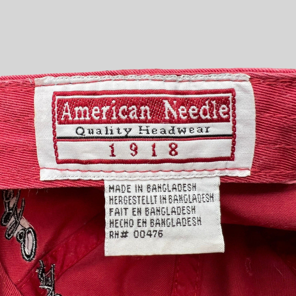 Raree Finds American Needle interior brand label and care tag inside a red cotton Starbucks strapback hat